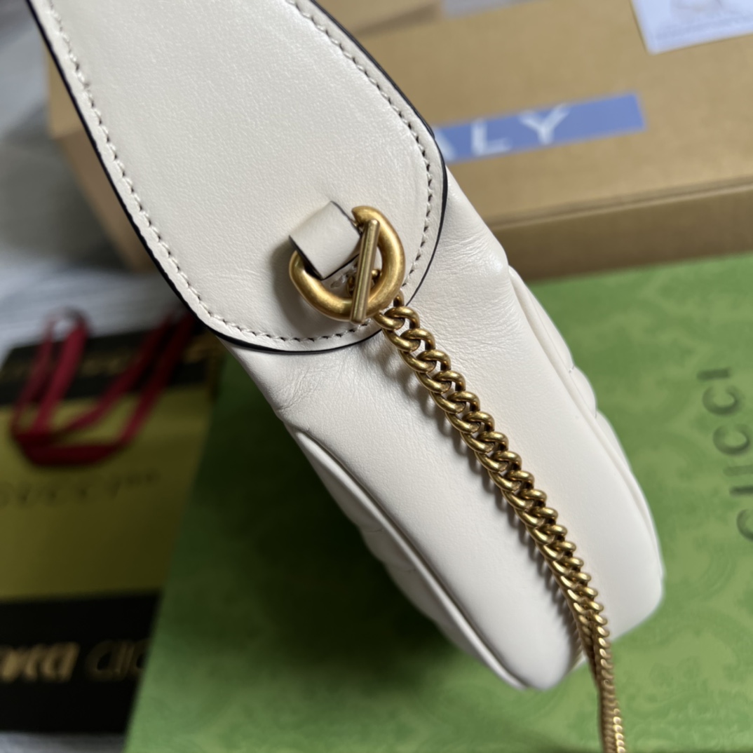 This mini handbag features a crescent-shaped silhouette and luxurious black leather, exuding a rich vintage style. - Image 4