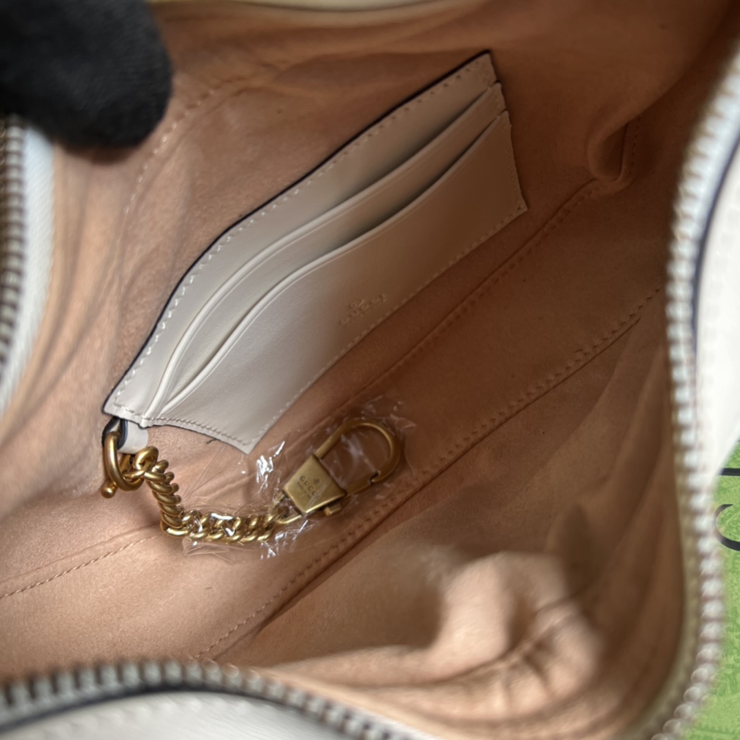 This mini handbag features a crescent-shaped silhouette and luxurious black leather, exuding a rich vintage style. - Image 5