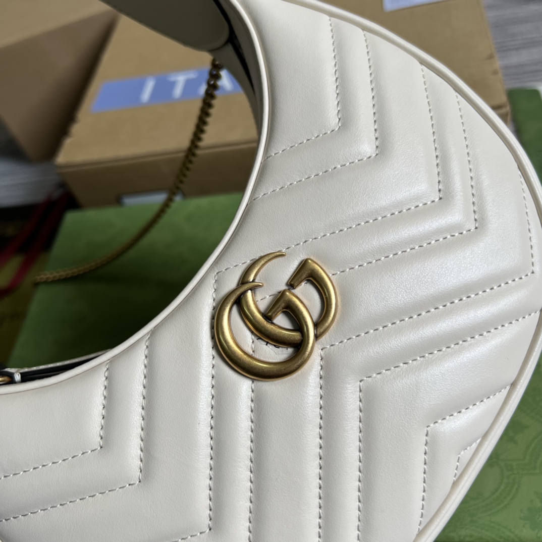 This mini handbag features a crescent-shaped silhouette and luxurious black leather, exuding a rich vintage style. - Image 6