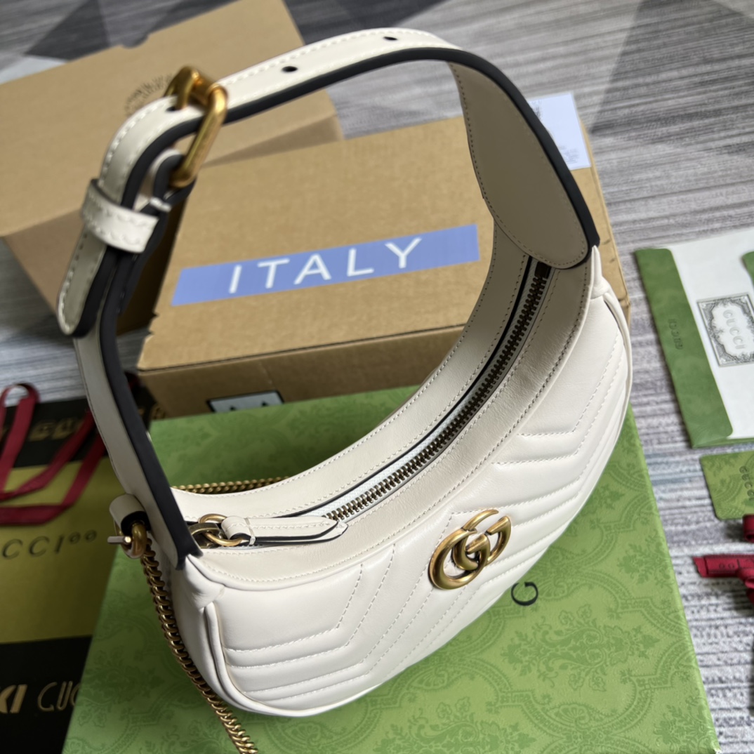 This mini handbag features a crescent-shaped silhouette and luxurious black leather, exuding a rich vintage style. - Image 8