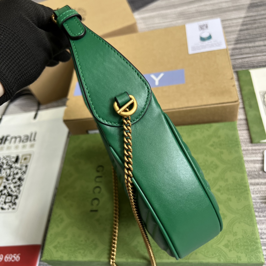 This mini handbag features a crescent-shaped silhouette and luxurious black leather, exuding a rich vintage style. - Image 5